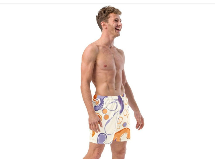 Smiling man wearing white swim shorts with bold orange and purple print – ccanvas men's swimwear