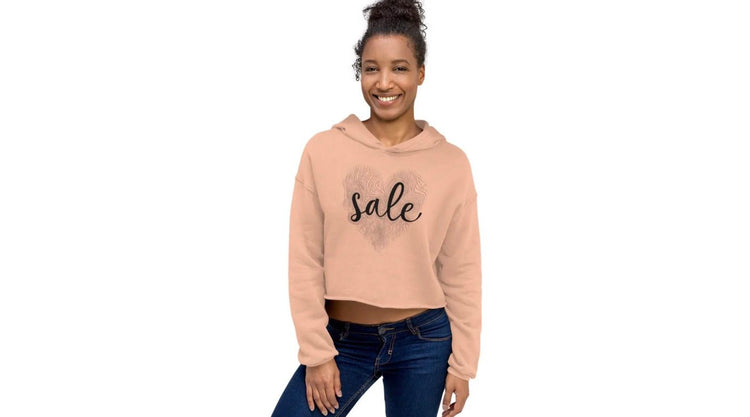 Young woman wearing peach cropped hoodie with “Sale” print – casual streetwear style from ccanvas