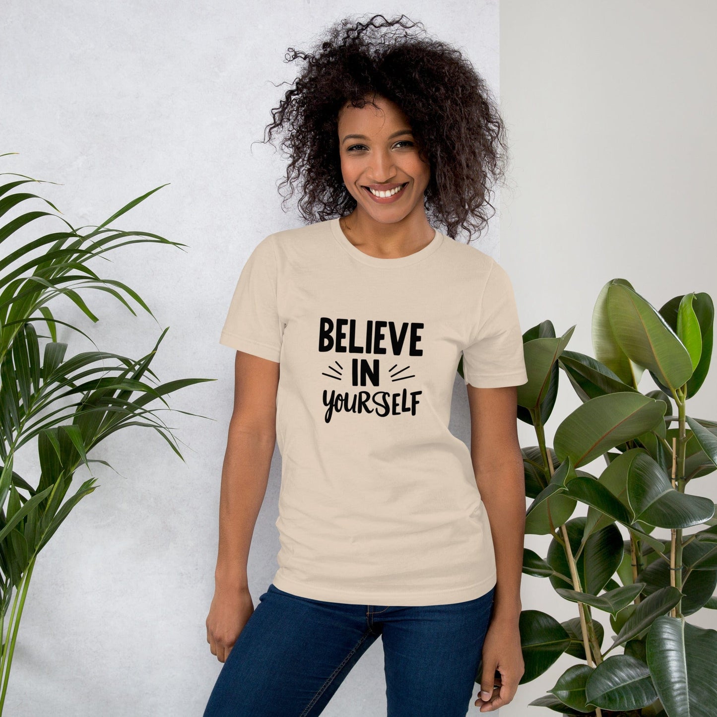 Smiling woman wearing beige Believe in Yourself T-shirt with black inspirational quote print – ccanvas