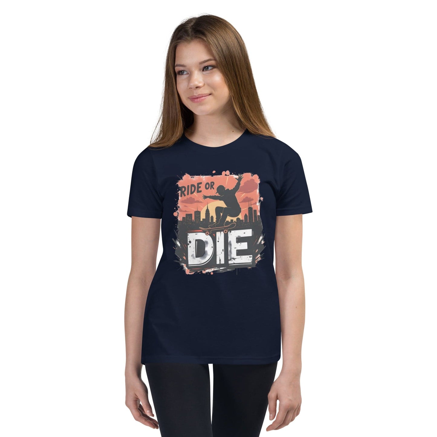 Teen girl wearing black T-shirt with “Ride or Die” text, skater silhouette, sunset city background and bold urban print – ccanvas