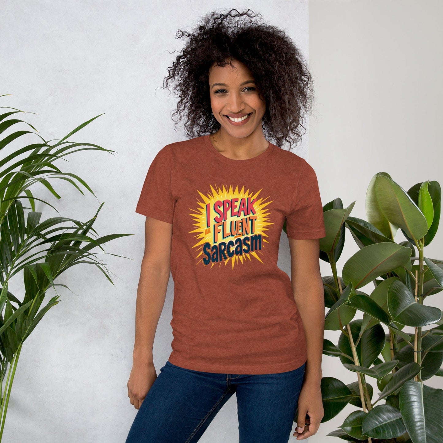 Woman wearing brown T-shirt with bold comic-style I Speak Fluent Sarcasm quote design – ccanvas