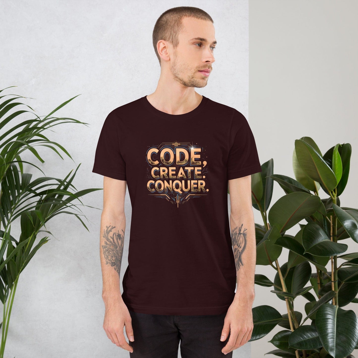 Man wearing dark red tech-style Code Create Conquer T-shirt with orange digital print design – ccanvas