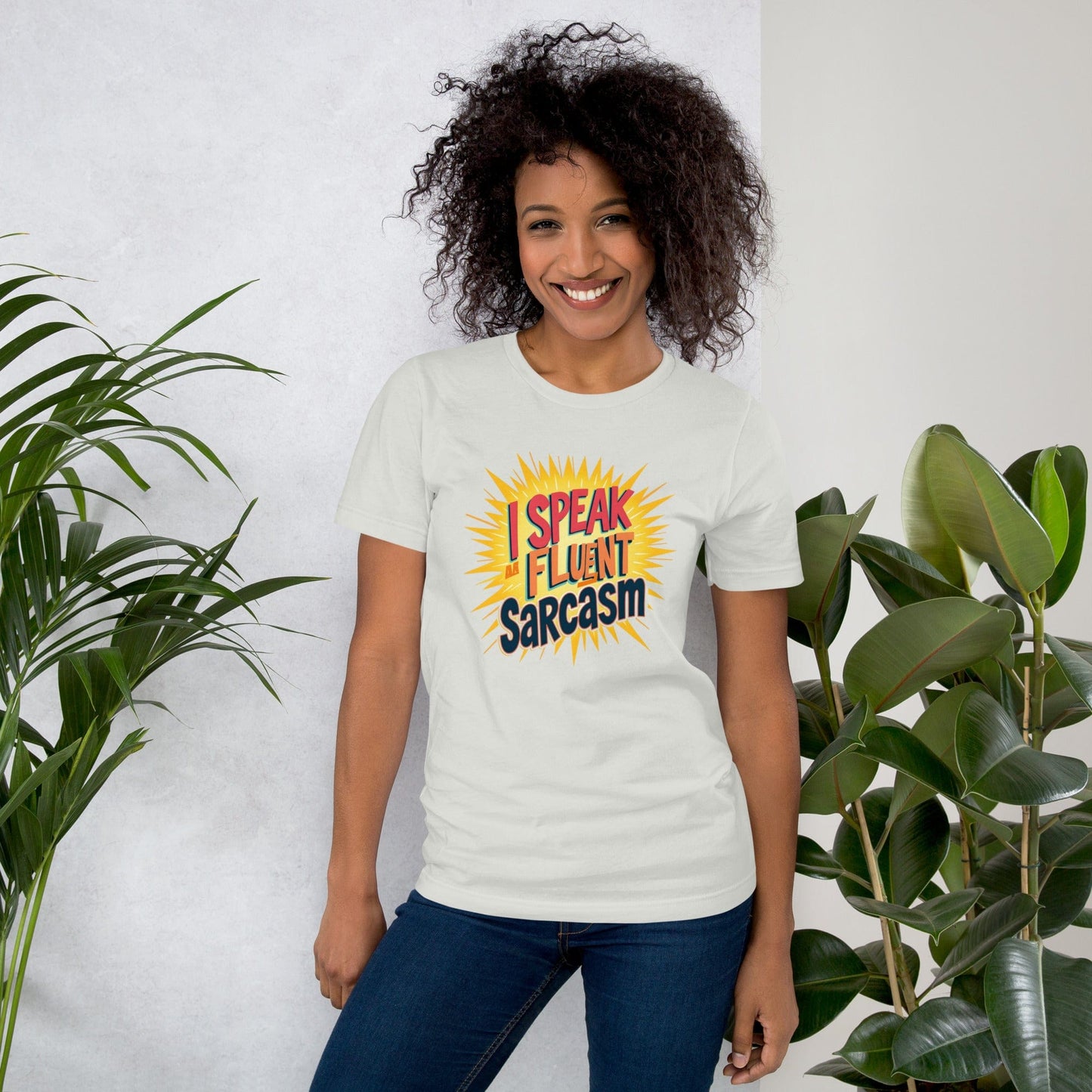 Woman wearing pink T-shirt with bold comic-style I Speak Fluent Sarcasm quote design – ccanvas