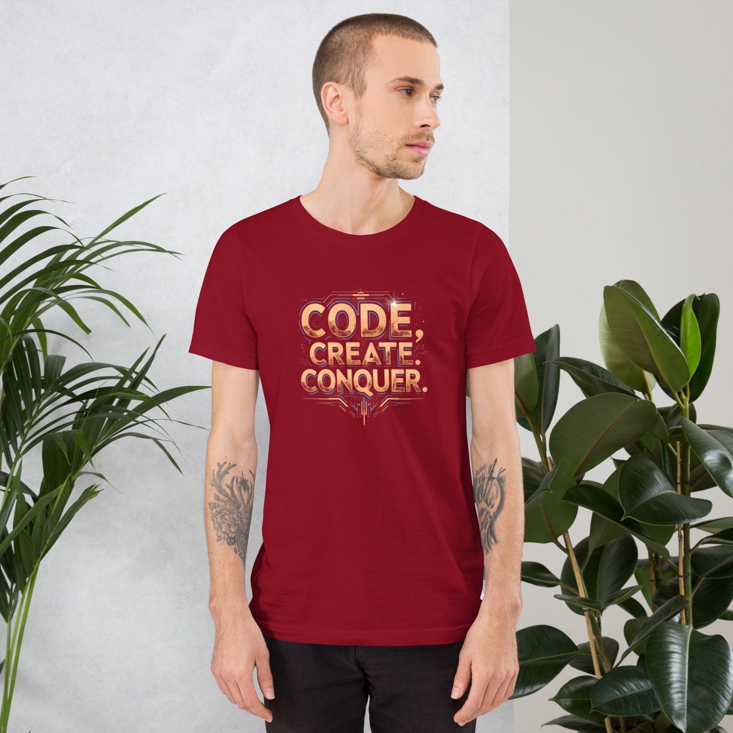Man wearing red tech-style Code Create Conquer T-shirt with orange digital print design – ccanvas