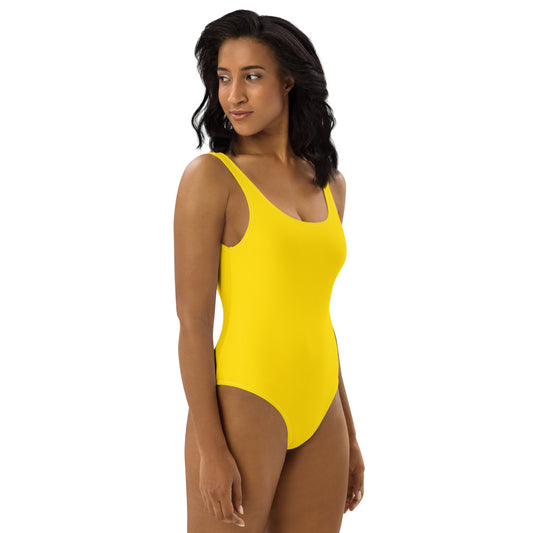 Side profile of women's Solstice Yellow swimsuit highlighting the body-sculpting athletic fit and premium stretch fabric by CCANVAS.
