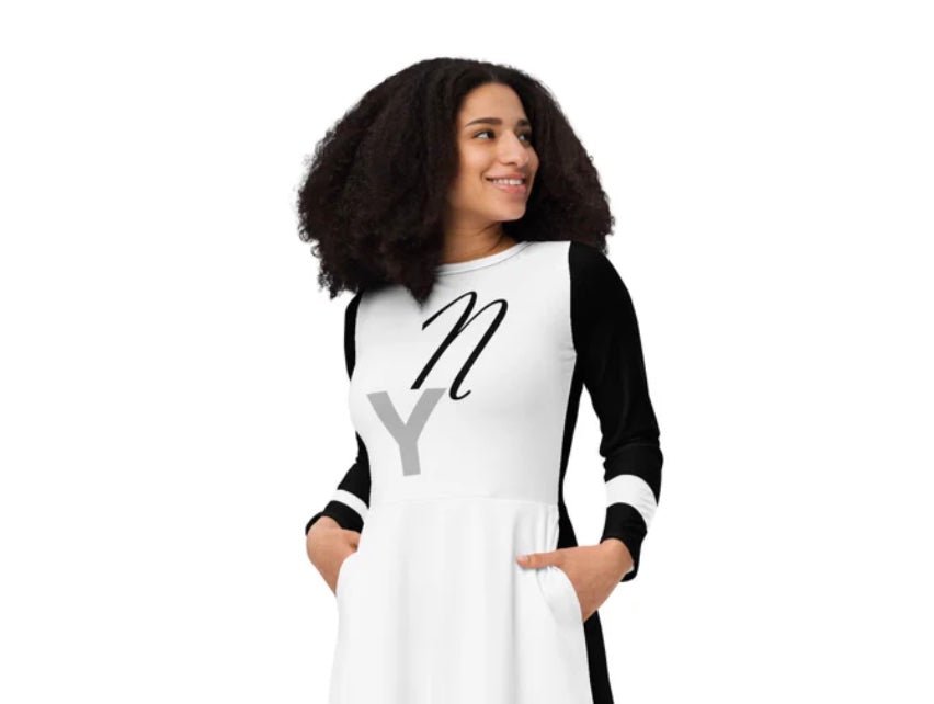 Striking NY street-style dress by ccanvas — black and white long-sleeve design with bold graphic, worn by model mid-pose in clean studio scene