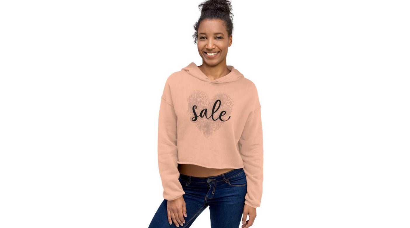 Young woman wearing peach cropped hoodie with “Sale” print – casual streetwear style from ccanvas