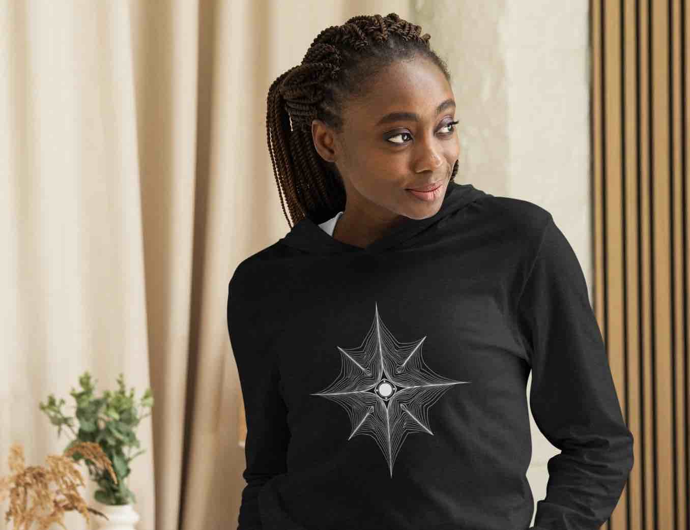 Woman wearing black graphic T-shirt with a starburst design – Women’s Artistic Statement Tee by ccanvas