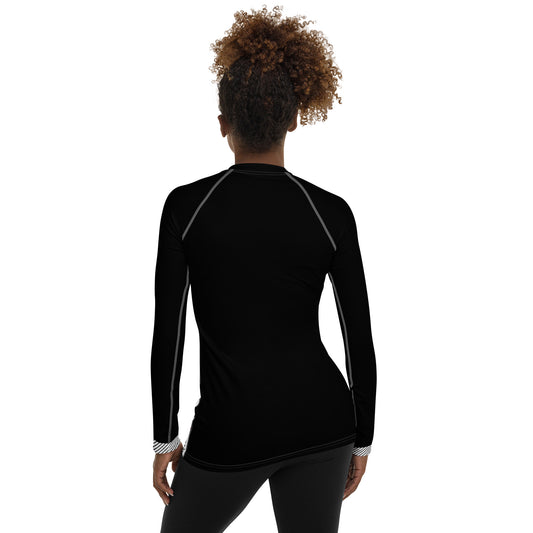 Woman wearing black and white plaid long sleeve top with red accents and logo on front vs1