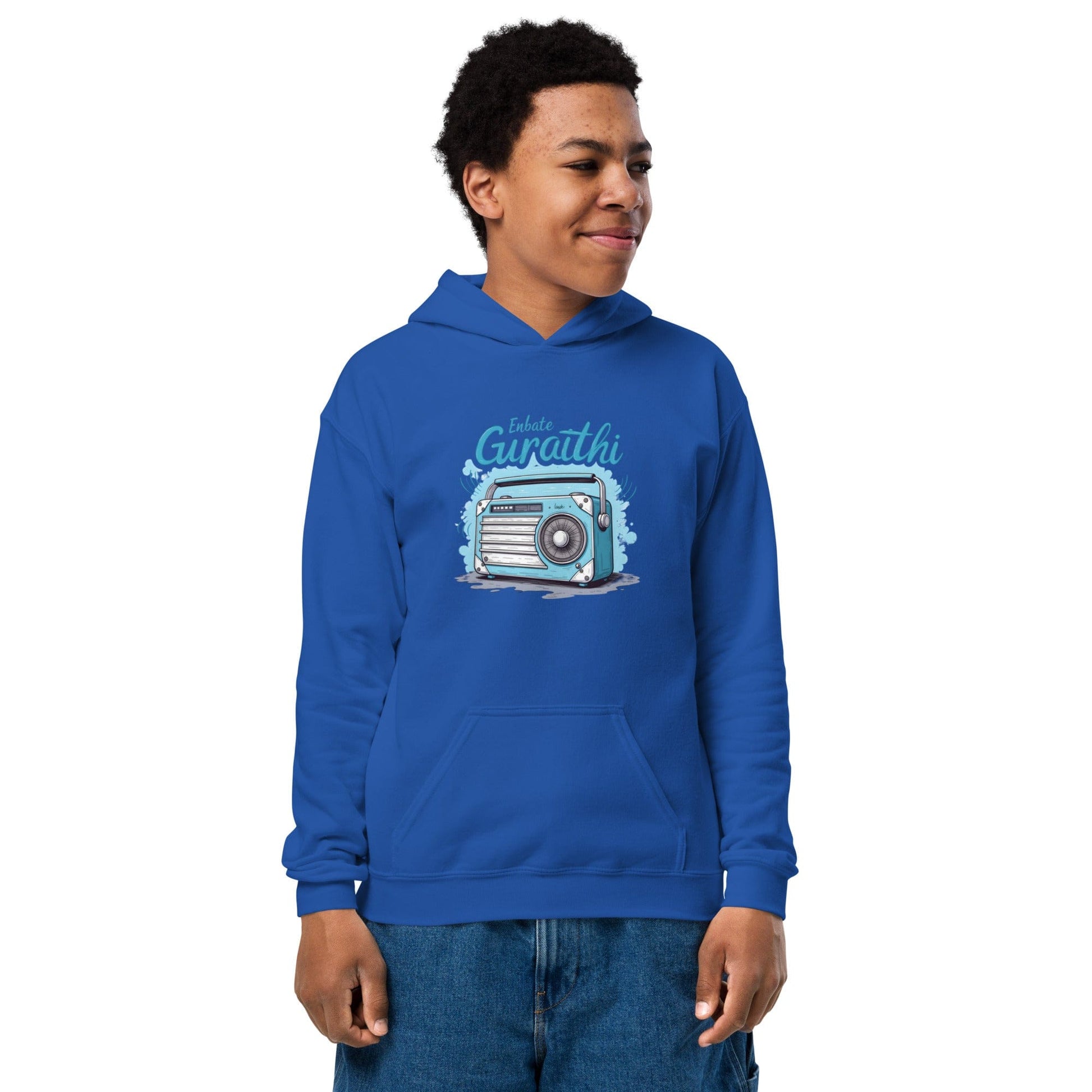 Teen wearing royal blue hoodie with vintage radio and “Iskulte Guraathi” slogan in playful style at ccanvas