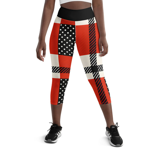 Woman wearing red black and white polka dot capri leggings with bold stripe design, mid-calf length, front view