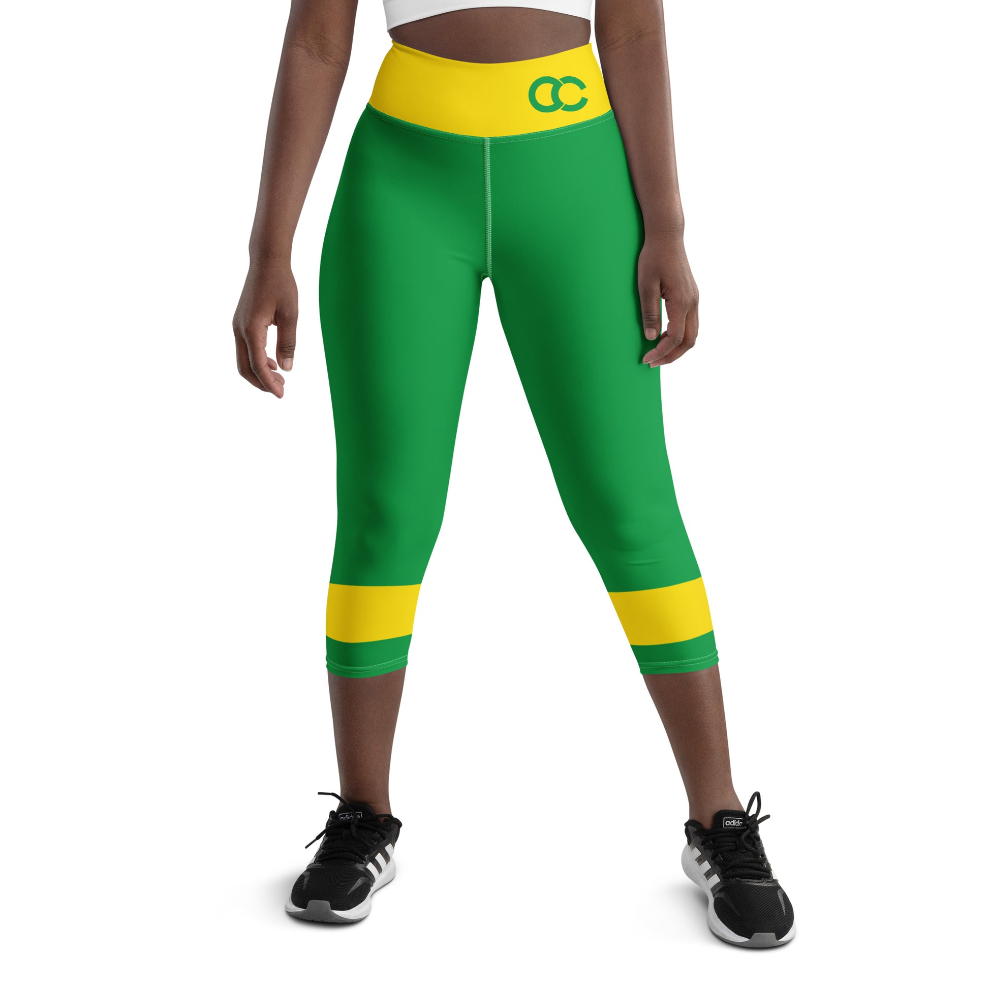 Model wearing green Brazil heritage leggings with a yellow waistband and CC monogram by CCANVAS.
