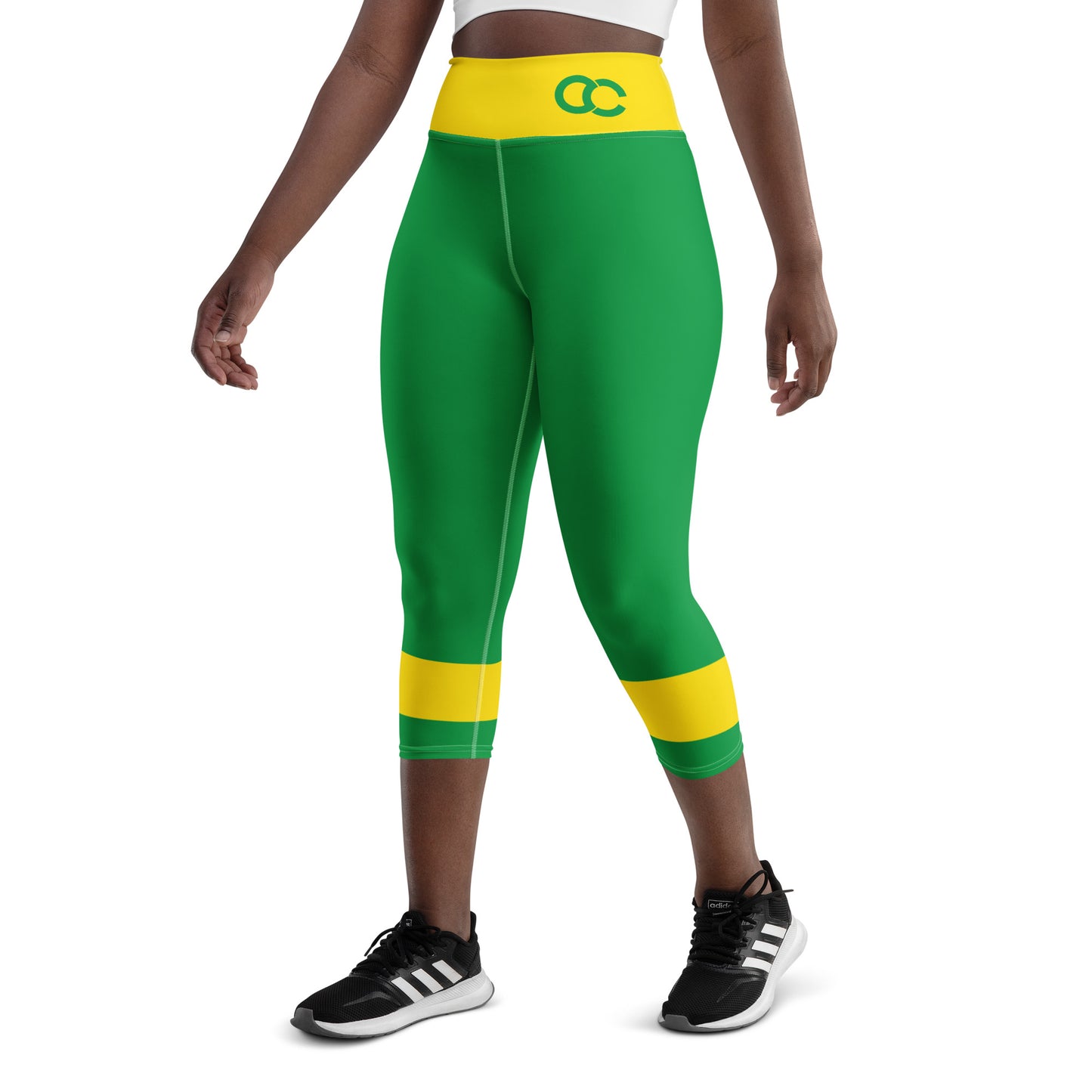 Side view of model standing in green Brazil heritage leggings with yellow details for athletic streetwear.

