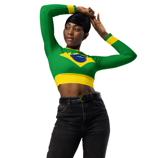 Side view of model in a green and yellow Brazil heritage crop top posing with black shorts and white shoes.

