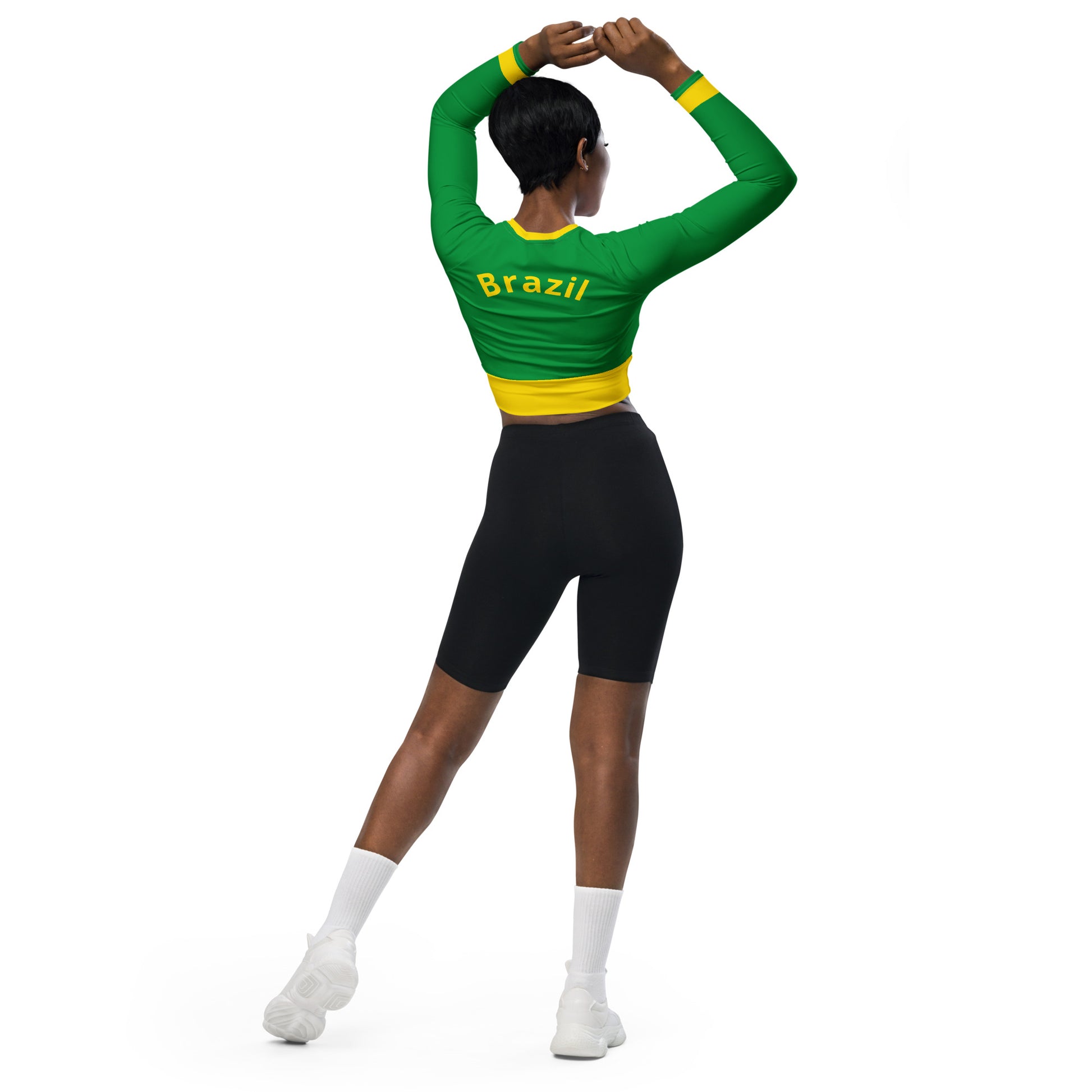 Back view of model wearing a green Brazil heritage crop top featuring a yellow collar and back stripe.
