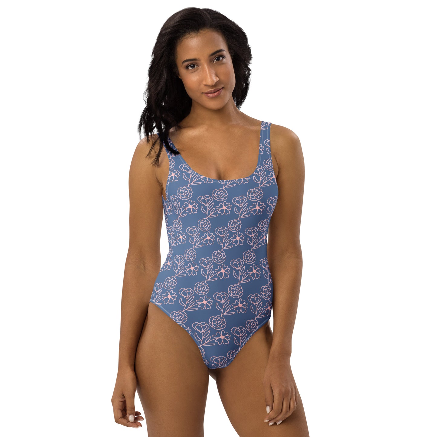 Model wearing a periwinkle blue one-piece swimsuit with a white hand-drawn floral print by CCANVAS.
