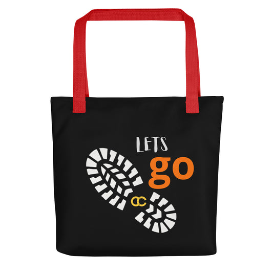 Black tote bag with sneaker sole graphic, Lets Go text, and vibrant red handles on heavyweight cotton canvas by CCANVAS.
