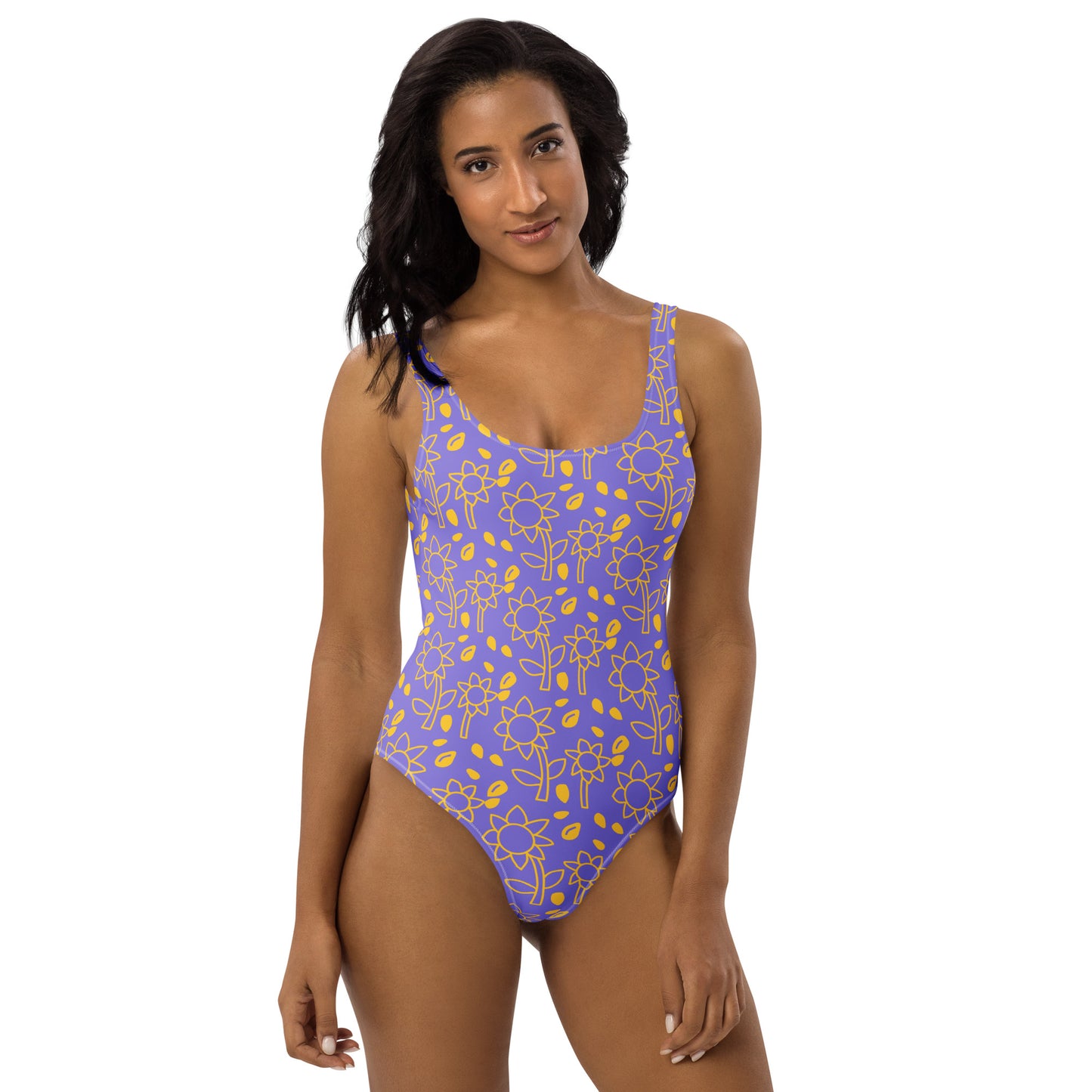 Model wearing a violet one-piece swimsuit with a golden sunflower all-over print by CCANVAS.
