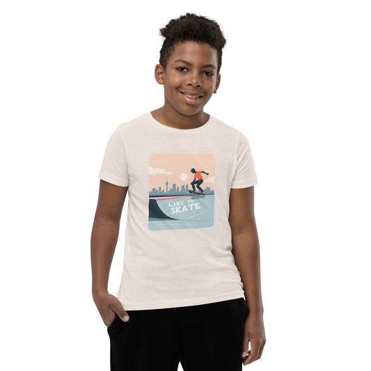 Boy wearing a Off White youth T-shirt with a skateboarding graphic and city skyline, reading “Live to Skate”