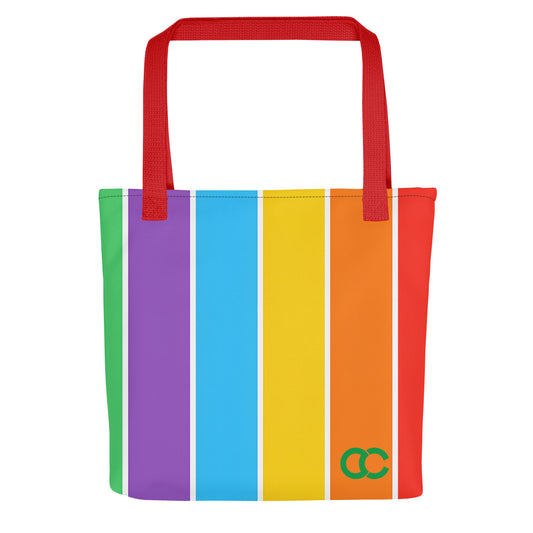 Vibrant rainbow vertical stripe tote bag with red handles and green CC logo on white heavyweight cotton canvas by CCANVAS.
