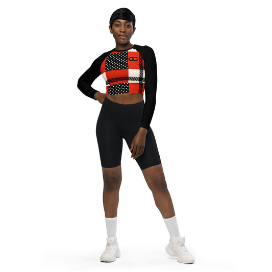 Woman wearing red polka dot crop top with patchwork design and black sleeves, fitted long-sleeve cut