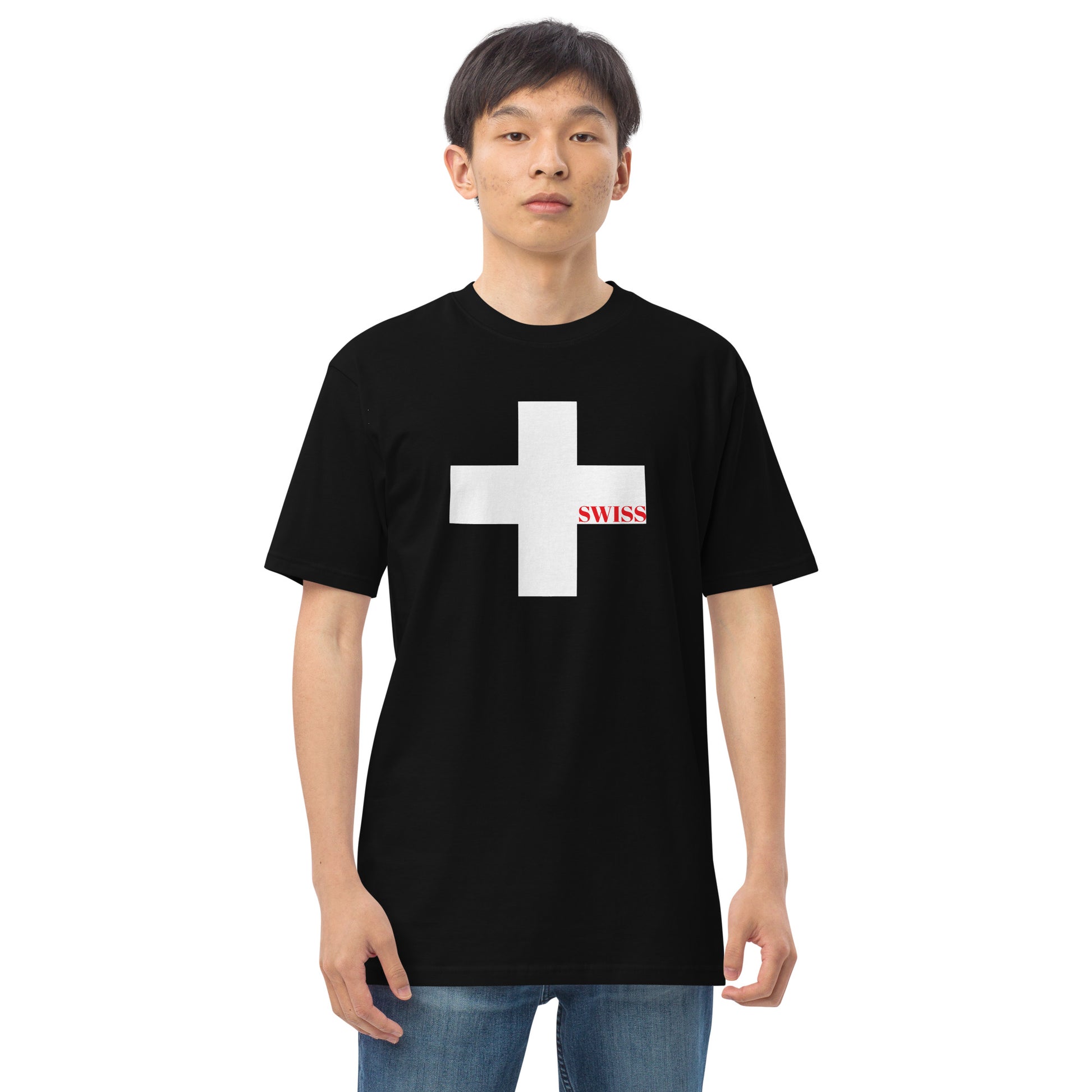 Model wearing a black Swiss heritage t-shirt with a large white Swiss cross and red text by CCANVAS.

