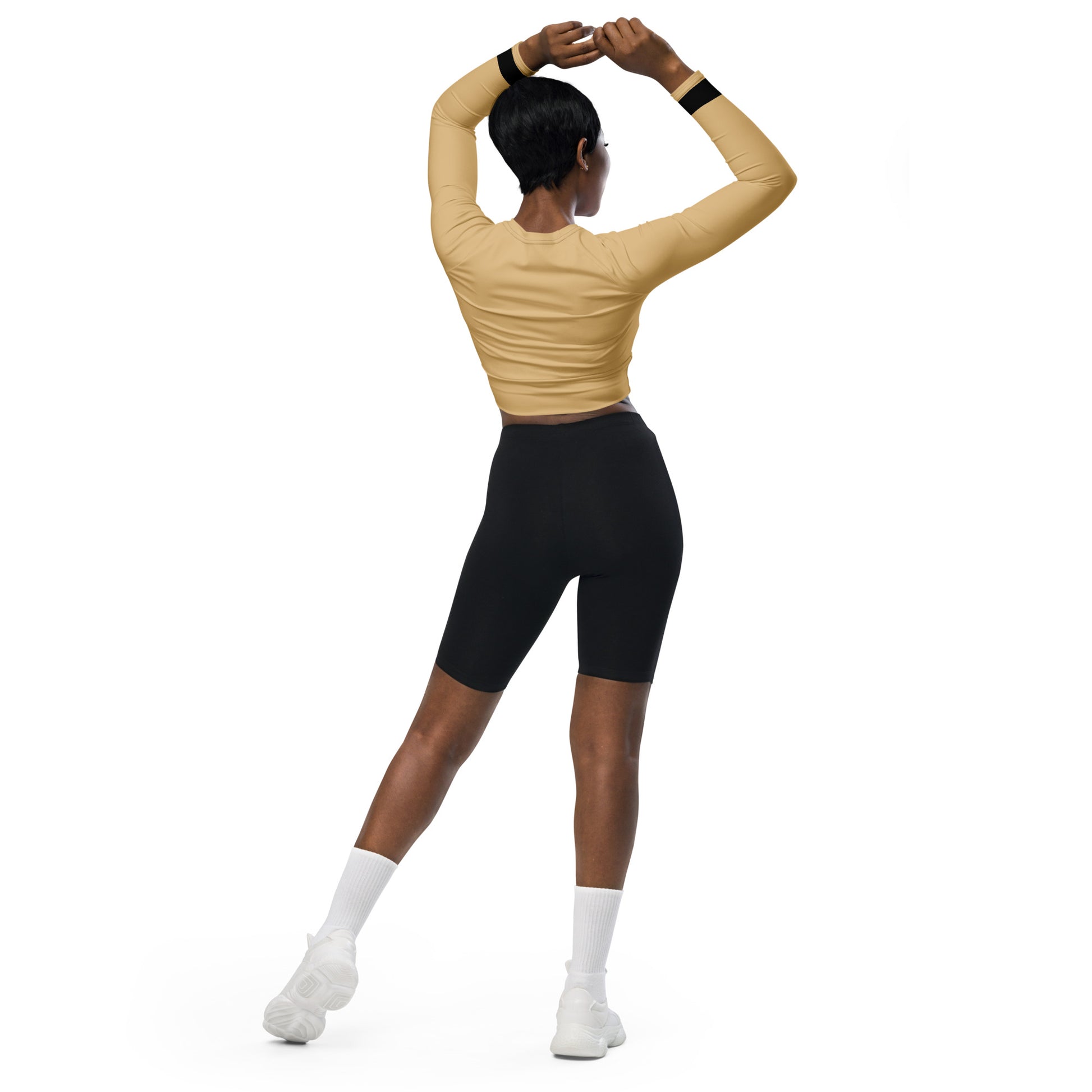 Back view of model wearing a long-sleeved urban plaid performance crop top for a sleek 2026 athletic look.
