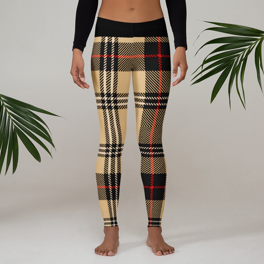 Model wearing high-waisted performance leggings with an urban sand and olive plaid pattern by CCANVAS.
