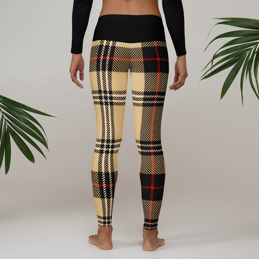 Back view of model in urban plaid leggings showing the black high-waisted band and earthy pattern.
