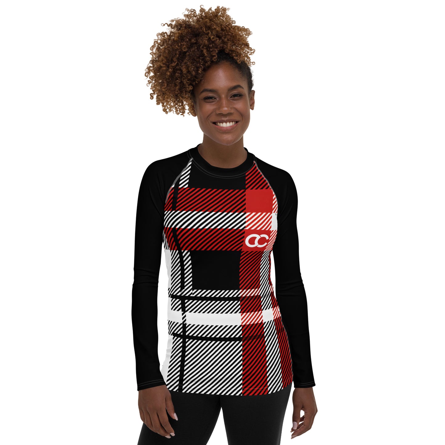 Model wearing a red and white plaid performance rash guard with black raglan sleeves by CCANVAS.

