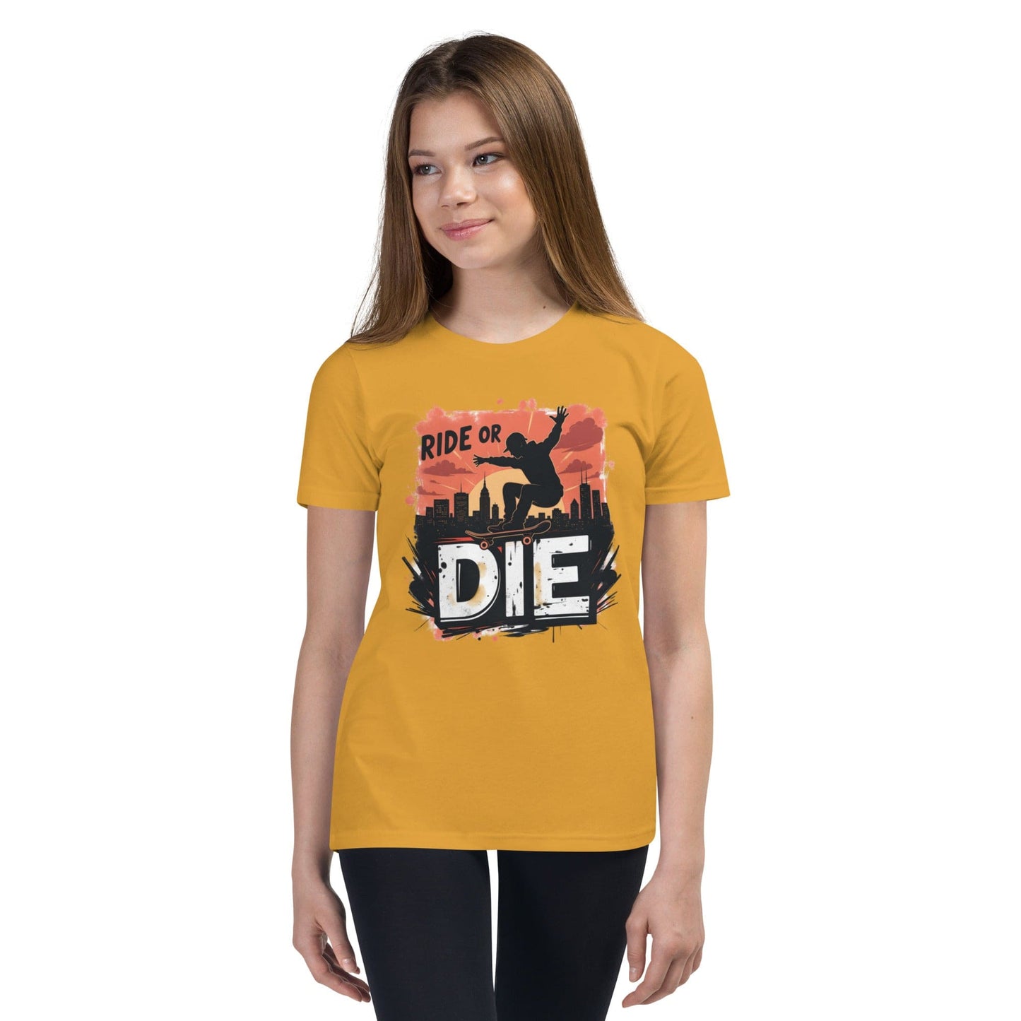 Teen girl wearing yellow T-shirt with “Ride or Die” text, skater silhouette, sunset city background and bold urban print – ccanvas