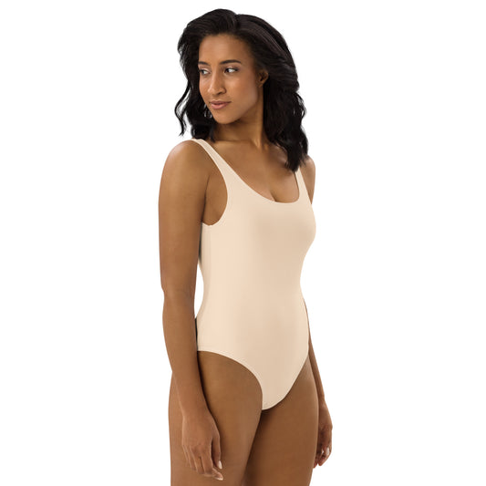 Rear view of women's Ivory Muse swimsuit showing the dramatic low-scoop back and high-cut athletic silhouette in ivory by CCANVAS.
